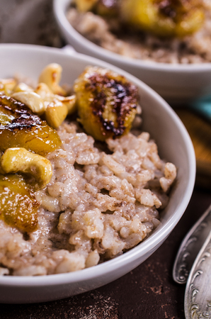 Rice porridge with banana and nuts. Selective focus.の写真素材