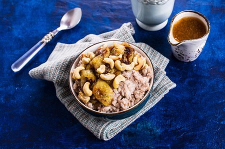 Rice porridge with banana and nuts. Selective focus.の写真素材