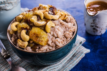 Rice porridge with banana and nuts. Selective focus.の写真素材