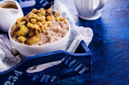 Rice porridge with banana and nuts. Selective focus.の写真素材
