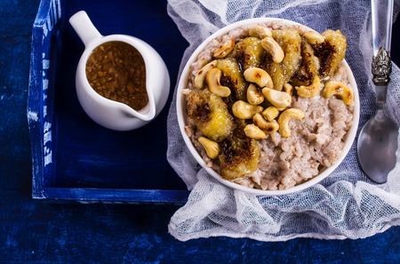 Rice porridge with banana and nuts. Selective focus.の写真素材