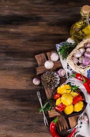 Marinated yellow pattypan and paprika on a wooden background. Selective focus.の写真素材