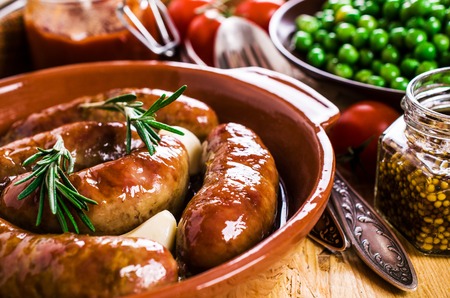 Baked meat sausages with vegetables and spices. Selective focus.の写真素材