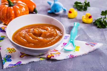 Homemade baby food from pumpkin and carrots. Selective focus.の写真素材