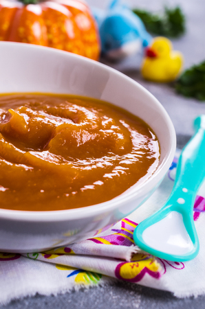 Homemade baby food from pumpkin and carrots. Selective focus.の写真素材
