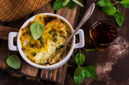 Casserole with pasta and peas in a serving bowl. Selective focus.の写真素材