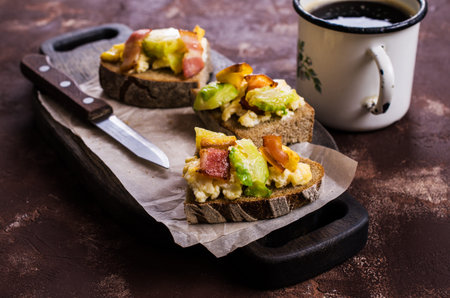Sandwich with vegetables, bacon and scrambled eggs. Selective focus.の写真素材