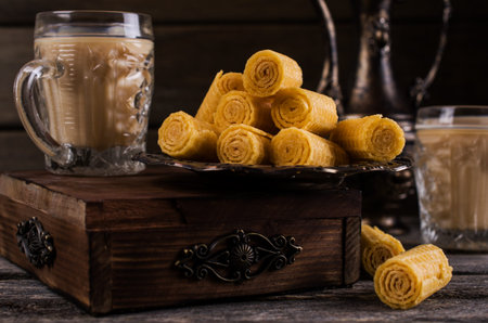 Crispy waffle rolls on a wooden background. Selective focus.の写真素材