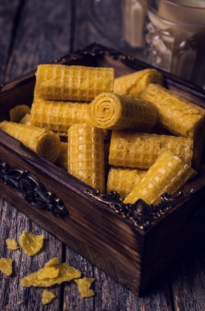 Crispy waffle rolls on a wooden background. Selective focus.の写真素材
