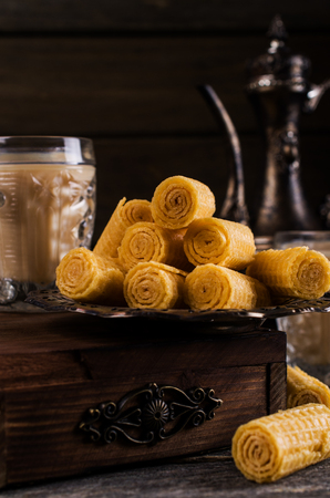 Crispy waffle rolls on a wooden background. Selective focus.の写真素材