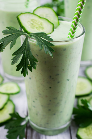 Smoothies with cucumber and parsley on a wooden background. Selective focus.の写真素材