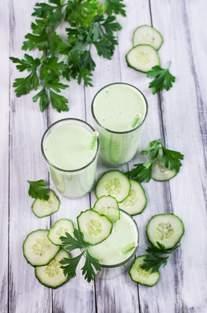 Smoothies with cucumber and parsley on a wooden background. Selective focus.の写真素材
