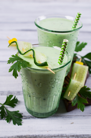 Smoothies with cucumber and parsley on a wooden background. Selective focus.の写真素材