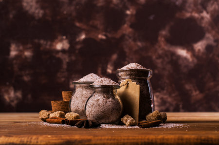 Dark sugar with cinnamon and anise on a wooden background. Selective focus.の写真素材