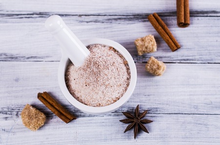 Dark sugar with cinnamon and anise on a wooden background. Selective focus.の写真素材
