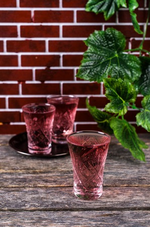 Transparent pink drink on a wooden background. Selective focus.の写真素材
