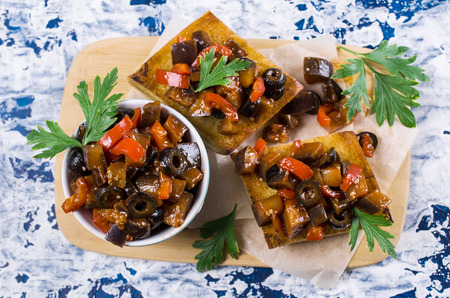 Stewed vegetables in sauce with parsley leaves and toast. Selective focus.の写真素材