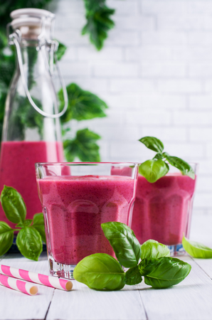 Beetroot smoothies in glass with basil on a wooden background. Selective focus.の写真素材
