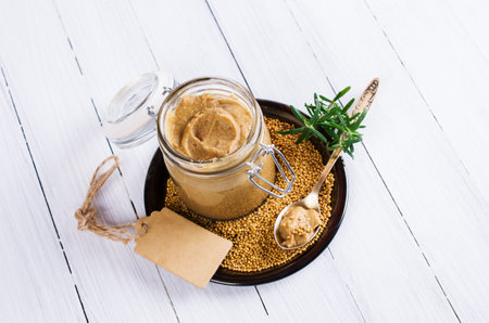 Homemade spicy mustard sauce wooden background. Selective focus.