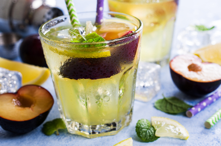 Drink with plums and lemon in the glass. Selective focus.の写真素材
