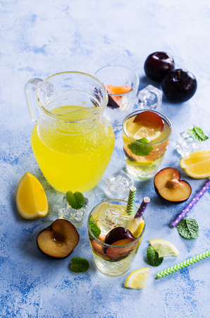 Drink with plums and lemon in the glass. Selective focus.の写真素材