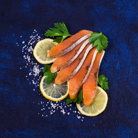 Sliced salted salmon with lemon and parsley. Selective focus.の写真素材