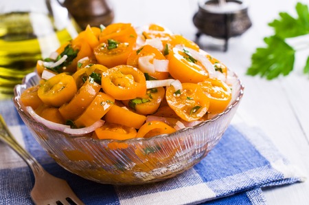 Salad of yellow tomato with onion and parsley. Selective focus.の写真素材