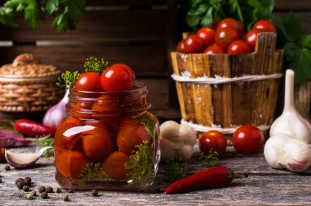 Marinated cherry tomatoes with spices on a wooden background. Selective focus.の写真素材