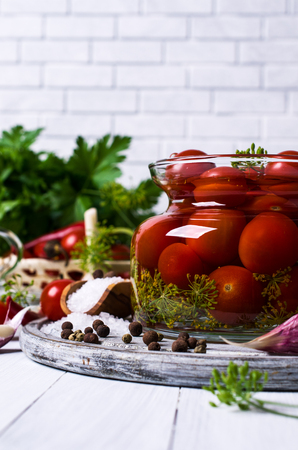 Marinated cherry tomatoes with spices on a wooden background. Selective focus.の写真素材
