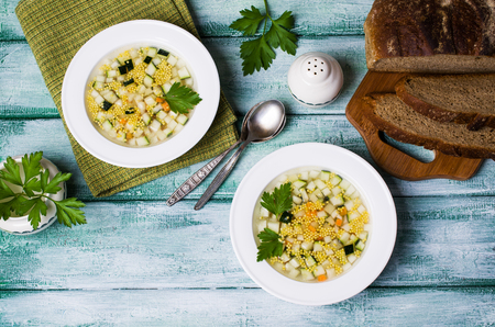 Soup with millet and vegetables on a wooden background. Selective focus.の写真素材