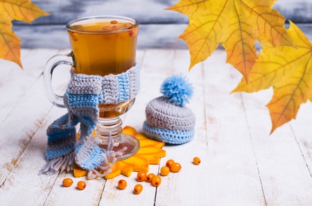 Transparent sea buckthorn drink in a glass on a wooden background. Selective focus.の写真素材