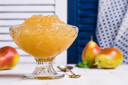 Jam from pears  in a glass on a wooden background. Selective focus.の写真素材