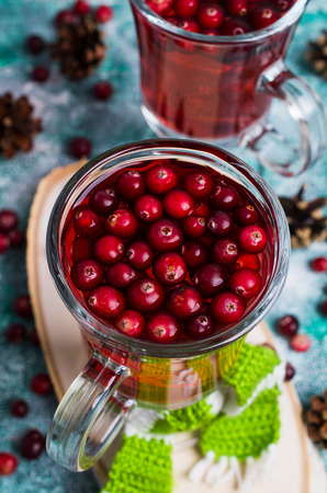 Transparent cranberry tea in glass on wooden background. Selective focus.の写真素材