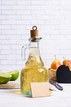Home made fruit vinegar on a light wooden background. Selective focus.の写真素材