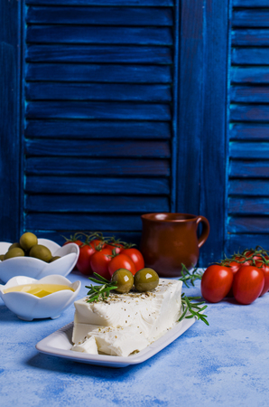Cheese feta with olives and rosemary on a concrete background. Selective focus.の写真素材