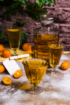 Transparent orange drink in glass on wooden background. Selective focus.の写真素材