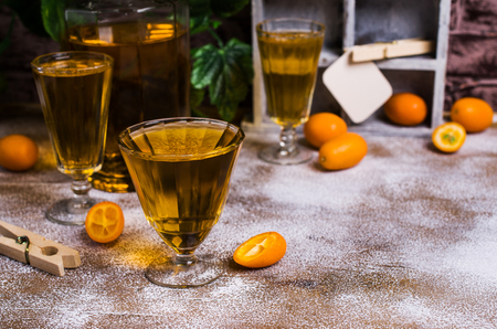 Transparent orange drink in glass on wooden background. Selective focus.の写真素材