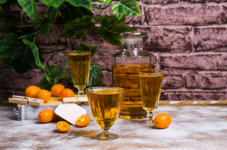 Transparent orange drink in glass on wooden background. Selective focus.の写真素材