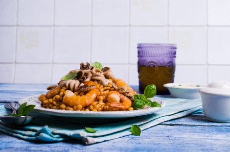 Seafood with shallow paste in tomato sauce on a wooden background. Selective focus.の写真素材