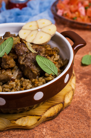 Rice with spices and meat with fried onions in a plate on the table. Selective focus.の写真素材