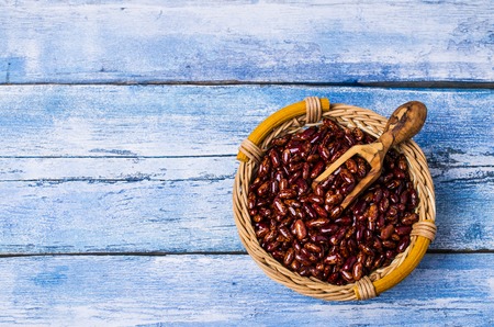 Raw pure mottled beans in bowl on wooden background. Selective focus.の写真素材
