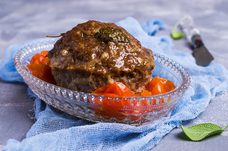 Traditional meatloaf with spices and vegetables on the table. Selective focus.の写真素材