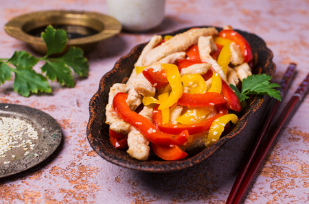 Fried slice of meat and pepper with sesame seeds on a stone background. Selective focus.の写真素材