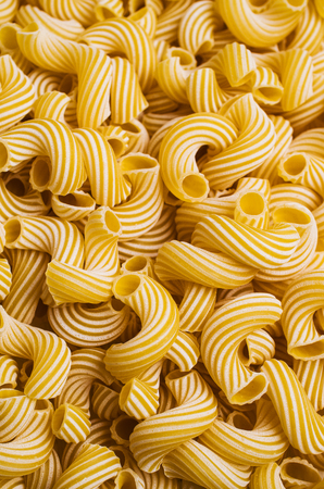 Traditional Italian pasta cavatappi with white stripes. Selective focus.の写真素材
