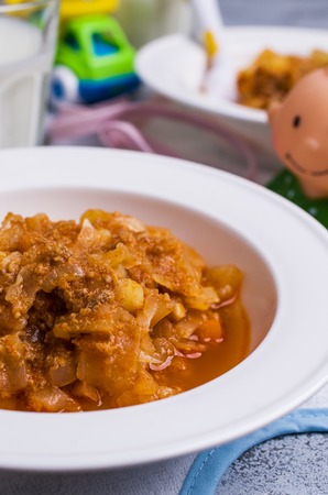 Thick soup for baby food with vegetables and meat in a bowl on wooden background. Selective focus.の写真素材