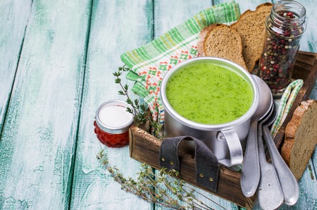 Green cream soup in a bowl on the table. Selective focus.の写真素材