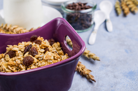 Traditional granola with raisins and nuts in a bowl on the table. Selective focus.の写真素材