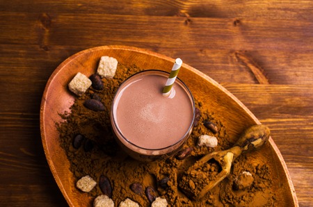 Traditional cocoa drink in glass on wooden background. Selective focus.の写真素材
