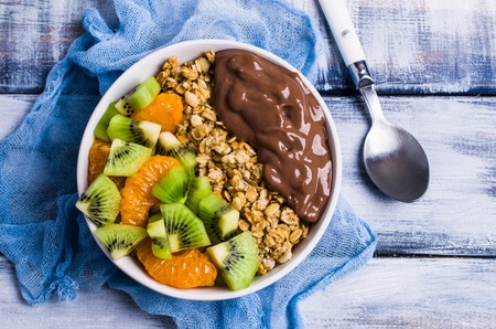 Granola with chocolate yogurt and raw fruit. Selective focus.の写真素材