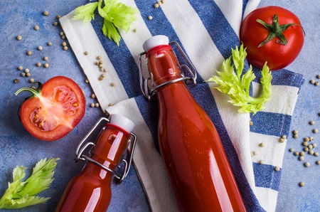 Thick tomato juice with celery and spices in a glass on the table. Selective focus.の写真素材
